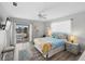 Bright bedroom features a walk-out balcony and calming blue accents at 1531 Placida Rd # 201, Englewood, FL 34223