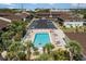 Aerial view of a sparkling pool surrounded by lounge chairs and palm trees at the Palm Manor community at 1531 Placida Rd # 201, Englewood, FL 34223