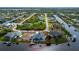 Waterfront home featuring a private dock and screened in lanai surrounded by lush landscaping and serene water views at 15674 Applewhite Cir, Port Charlotte, FL 33981