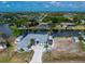 Waterfront home with a long driveway, dock, and room for an RV, surrounded by lush landscaping and serene water views at 15674 Applewhite Cir, Port Charlotte, FL 33981
