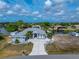 A beautiful home featuring lush landscaping, a long driveway, and waterfront views and easy access to the water at 15674 Applewhite Cir, Port Charlotte, FL 33981