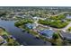 Waterfront home featuring a private dock and screened in lanai surrounded by lush landscaping and serene water views at 15674 Applewhite Cir, Port Charlotte, FL 33981
