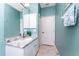 Bright bathroom with white vanity, granite counters, and a large mirror at 15674 Applewhite Cir, Port Charlotte, FL 33981