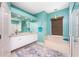 This primary bathroom features an undermount tub, a large mirror, recessed lighting, and travertine countertops at 15674 Applewhite Cir, Port Charlotte, FL 33981