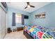 Nautical-themed bedroom with bright quilt, ceiling fan, and natural light at 15674 Applewhite Cir, Port Charlotte, FL 33981