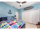 Bedroom featuring tile floors, nautical decor, ceiling fan, and large closet at 15674 Applewhite Cir, Port Charlotte, FL 33981