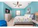 Bedroom with tile flooring, blue walls, ceiling fan, and matching grey dresser and side table at 15674 Applewhite Cir, Port Charlotte, FL 33981
