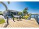 Spacious wooden dock with chairs overlooking the water, providing direct access to the serene waterways at 15674 Applewhite Cir, Port Charlotte, FL 33981