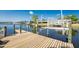 Private wooden dock with a boat lift, providing direct access to the serene waters and boating opportunities at 15674 Applewhite Cir, Port Charlotte, FL 33981