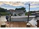 View from the dock of boat and lift on the water with waterfront homes in the background at 15674 Applewhite Cir, Port Charlotte, FL 33981
