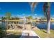 Private wooden dock, perfect for enjoying waterfront views and accessing boat activities on a sunny day at 15674 Applewhite Cir, Port Charlotte, FL 33981