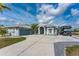 Charming home featuring a wide driveway, RV parking, and well-maintained landscaping for a welcoming curb appeal at 15674 Applewhite Cir, Port Charlotte, FL 33981