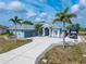 Beautiful home with a wide driveway, RV parking, and lush landscaping creating a welcoming and well-maintained exterior at 15674 Applewhite Cir, Port Charlotte, FL 33981
