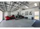 Spacious garage with epoxy floors, ceiling fan, workout equipment, and motorcycle parking at 15674 Applewhite Cir, Port Charlotte, FL 33981