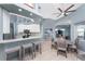 Bright, open kitchen with granite countertops, stainless steel appliances, and a breakfast bar overlooking the dining area at 15674 Applewhite Cir, Port Charlotte, FL 33981