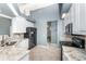 Galley kitchen featuring white cabinets, granite countertops, stainless steel appliances, and tile floors at 15674 Applewhite Cir, Port Charlotte, FL 33981