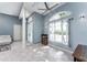 Bright living room featuring tile floors, large windows, and an elegant design perfect for relaxing and entertaining guests at 15674 Applewhite Cir, Port Charlotte, FL 33981