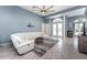 Inviting living room featuring tile floors, ample seating, and an open layout perfect for entertaining and relaxation at 15674 Applewhite Cir, Port Charlotte, FL 33981