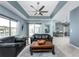 Comfortable living room featuring tile flooring, a tray ceiling, and an open layout with waterfront views at 15674 Applewhite Cir, Port Charlotte, FL 33981