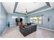 Living room features a leather sofa and a TV and canal view at 15674 Applewhite Cir, Port Charlotte, FL 33981