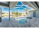 Screened-in pool area with waterfront view and outdoor seating at 15674 Applewhite Cir, Port Charlotte, FL 33981