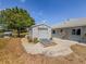 A well-maintained shed stands near the house, featuring a metal door and concrete ramp set in a rock landscape at 15674 Applewhite Cir, Port Charlotte, FL 33981