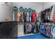 Walk-in closet includes plentiful shelving and clothing racks, along with a black chest of drawers and a blue carpet at 15674 Applewhite Cir, Port Charlotte, FL 33981