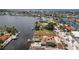 Aerial view of a waterfront home featuring a boat dock, tiki hut, and pool in a quiet residential neighborhood at 158 Morgan Se Ln, Port Charlotte, FL 33952