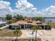 Beautiful home with a private waterfront location, lush landscaping, and solar panels for energy efficiency at 158 Morgan Se Ln, Port Charlotte, FL 33952