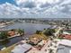 Aerial view of a waterfront home featuring a boat dock and access to the water in a quiet residential neighborhood at 158 Morgan Se Ln, Port Charlotte, FL 33952