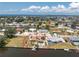 Aerial view of a waterfront home featuring a boat dock, tiki hut, and pool in a quiet residential neighborhood at 158 Morgan Se Ln, Port Charlotte, FL 33952