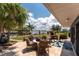 Covered patio with outdoor seating with lush landscaping on a waterfront property at 158 Morgan Se Ln, Port Charlotte, FL 33952