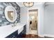 Bathroom featuring navy cabinets, white countertops, decorative backsplash, and a walk-in shower at 158 Morgan Se Ln, Port Charlotte, FL 33952