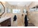 Bathroom featuring dark cabinets, white countertops, decorative backsplash, and walk-in shower with glass at 158 Morgan Se Ln, Port Charlotte, FL 33952