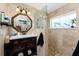 A full bathroom with an octagonal mirror, a modern vanity, decorative tile and a glass-enclosed shower at 158 Morgan Se Ln, Port Charlotte, FL 33952