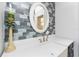 Bathroom featuring navy cabinets, white countertops and sink, with a decorative backsplash at 158 Morgan Se Ln, Port Charlotte, FL 33952