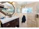 Bathroom featuring dark cabinets, white countertops, decorative backsplash, and walk-in shower with glass at 158 Morgan Se Ln, Port Charlotte, FL 33952
