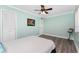 A calming bedroom features serene light blue walls, wood-look flooring, and bright natural light at 158 Morgan Se Ln, Port Charlotte, FL 33952