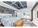 Bright bedroom with coffered ceiling, water-themed decor and sliding door access to the outdoors at 158 Morgan Se Ln, Port Charlotte, FL 33952