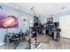 Home recording studio features blue walls, wood-look floors, and professional recording equipment at 158 Morgan Se Ln, Port Charlotte, FL 33952