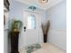 Bright entryway featuring decorative accents, ceramic tile, and a glass front door at 158 Morgan Se Ln, Port Charlotte, FL 33952