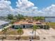 Beautiful view of a single story home with well kept lawn, blue exterior, and canal access at 158 Morgan Se Ln, Port Charlotte, FL 33952