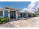 Attractive home with a landscaped front yard and a charming facade enhanced by the American flag and tasteful details at 158 Morgan Se Ln, Port Charlotte, FL 33952