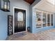Up close view of the front door, with beautiful walkway, welcome sign, and blue exterior at 158 Morgan Se Ln, Port Charlotte, FL 33952