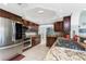 A kitchen featuring stainless steel appliances, granite countertops, and dark wood cabinetry at 158 Morgan Se Ln, Port Charlotte, FL 33952