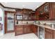 Kitchen showcases cherry cabinets, wine rack, pantry, granite countertop and stainless microwave at 158 Morgan Se Ln, Port Charlotte, FL 33952