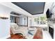 Open-concept living room with hardwood floors, statement fireplace, and seamless access to bedroom at 158 Morgan Se Ln, Port Charlotte, FL 33952