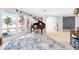 Bright living room featuring a baby grand piano and large windows offering lots of sunlight at 158 Morgan Se Ln, Port Charlotte, FL 33952