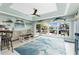 A waterfront living room with light blue walls, decorative fish, and sliding doors leading to the outside at 158 Morgan Se Ln, Port Charlotte, FL 33952