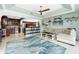 Living room with a waterfront view, blue area rug, and kitchen access with bar stool seating at 158 Morgan Se Ln, Port Charlotte, FL 33952